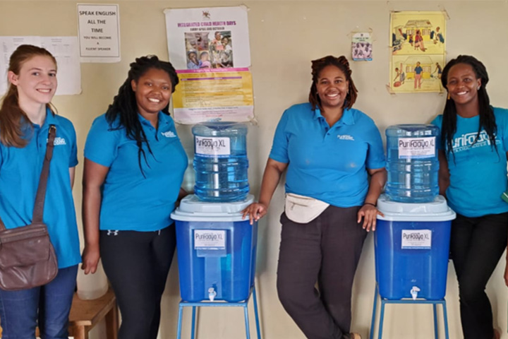 Dow Fellows team members install filtered water coolers in a local school to protect children from deadly diarrheal disease.