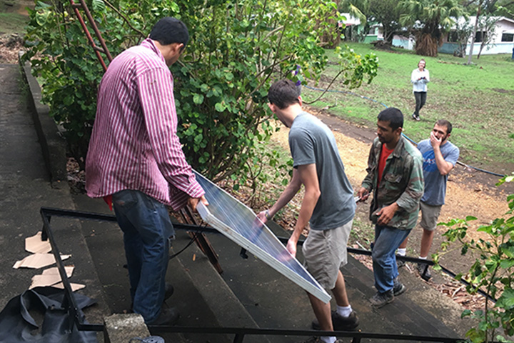 Students assist with installing solar panels at the Taboga Reserve research field station. Photo by Dr. Jose Alfaro